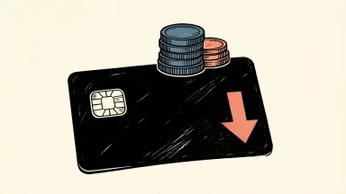 American Express credit card supporting a stack of coins with a downward arrow, representing improved write-off rates.
